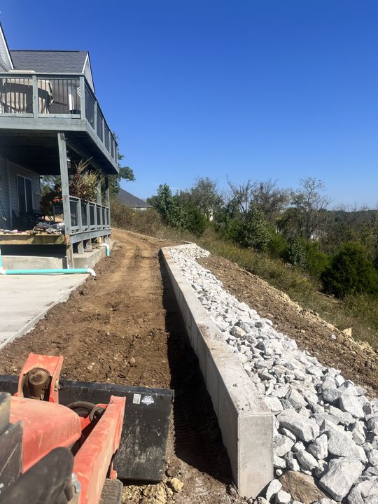 Site work alongside a retaining wall