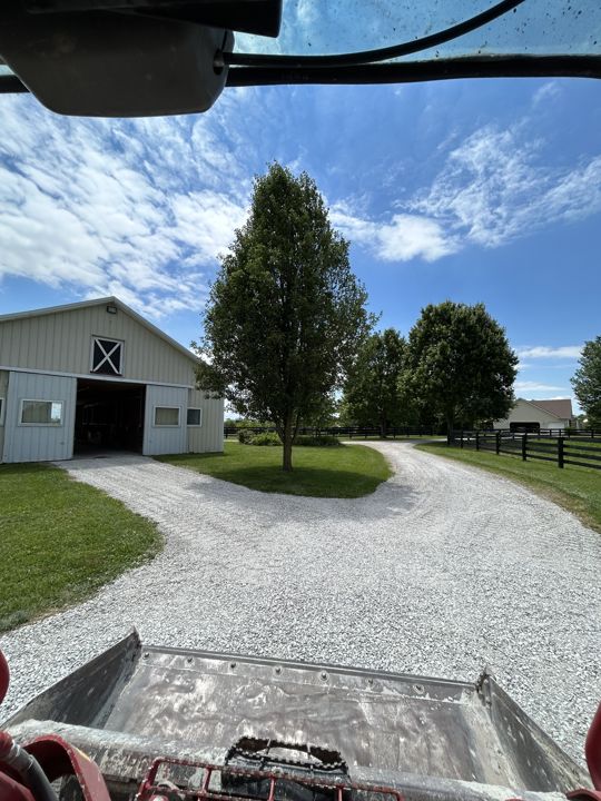 Gravel driveway around a barn